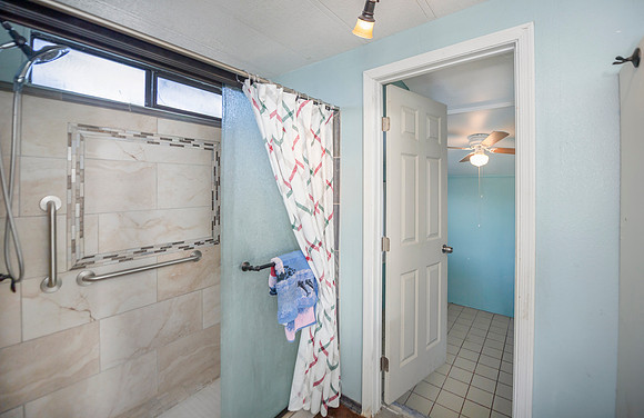 DSC_7901 master bathroom showing door to room in back of the house