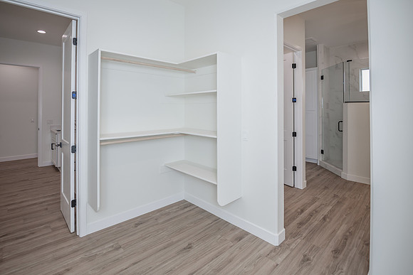 master closet with laundry and bathroom